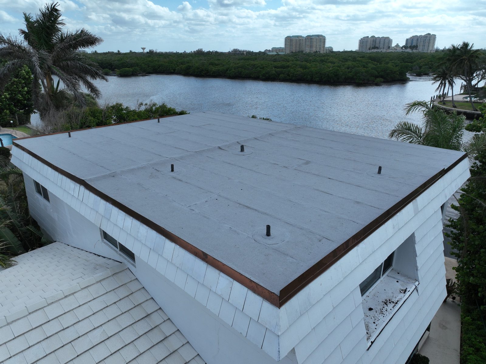 Modified bitumen flat roof replacement on a coastal building