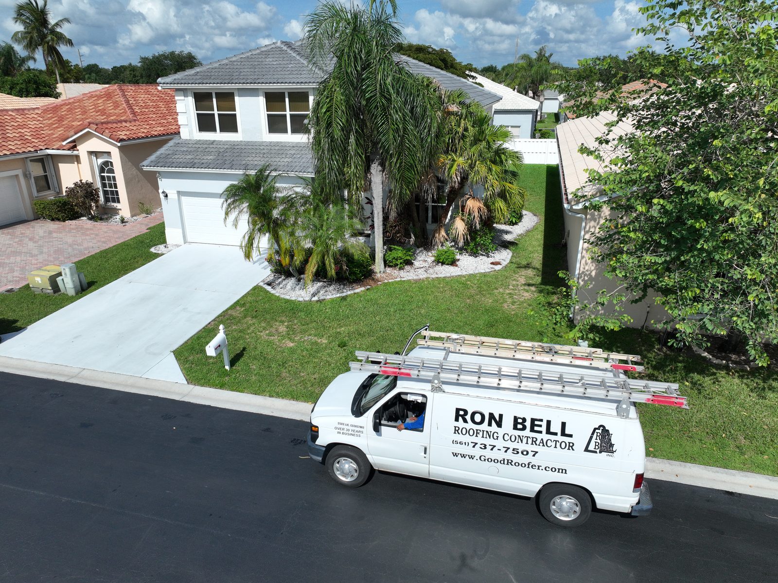 Ron Bell Roofing service van at a completed South Florida job