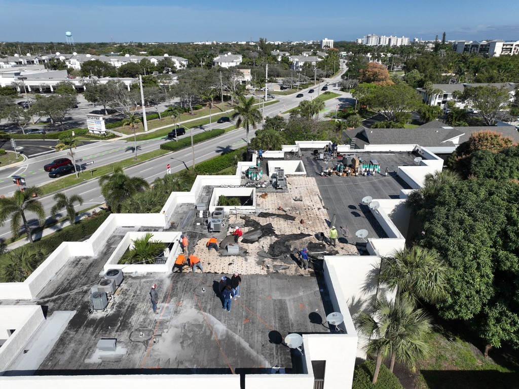 Ron Bell Commercial Roofing, Roofer sealing flashing and replacing damaged shingles on coastal Palm Beach home